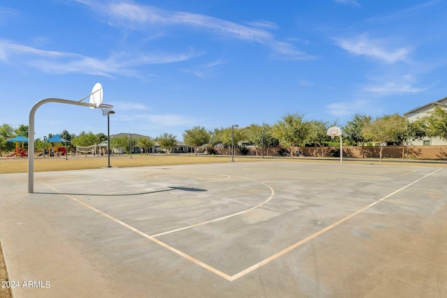 view of basketball court with a playground