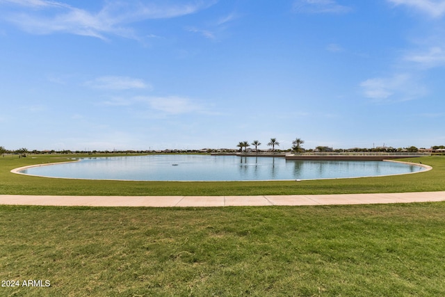 view of dock with a water view and a yard