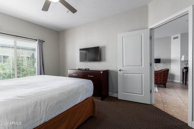 bedroom featuring ceiling fan and light tile patterned floors