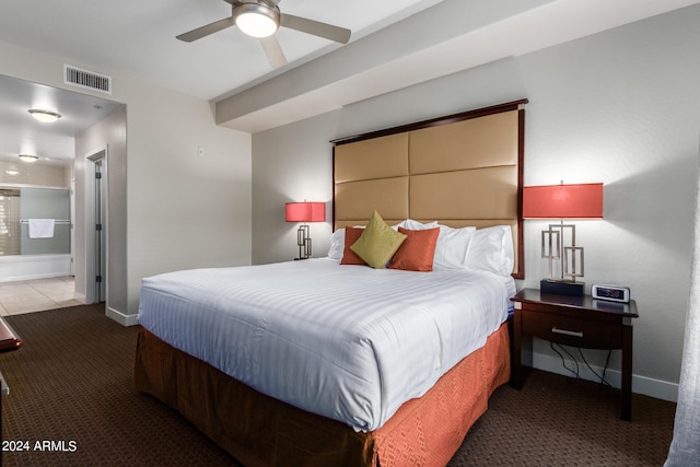 carpeted bedroom featuring ensuite bath and ceiling fan