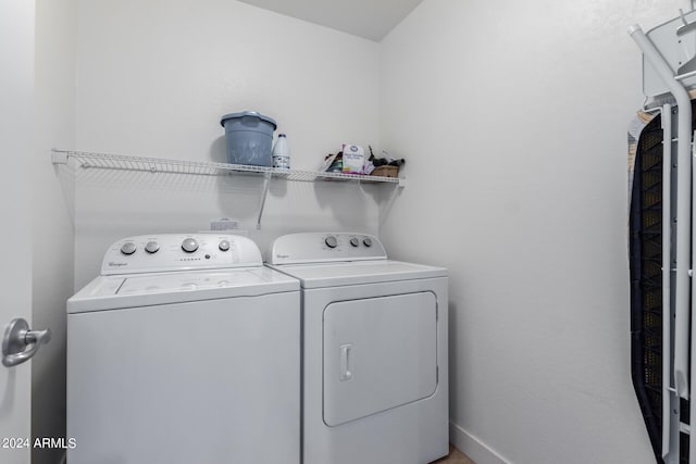 clothes washing area with washing machine and dryer