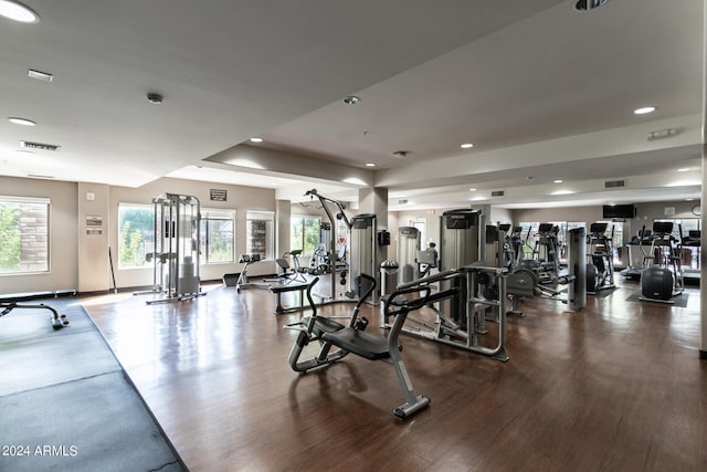 exercise room with hardwood / wood-style floors