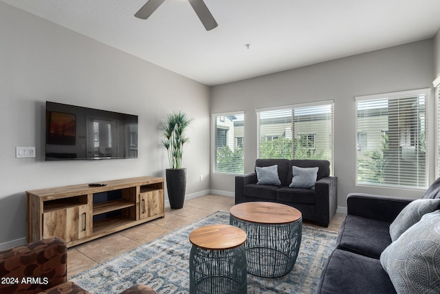 living room featuring ceiling fan, a wealth of natural light, and light tile patterned flooring