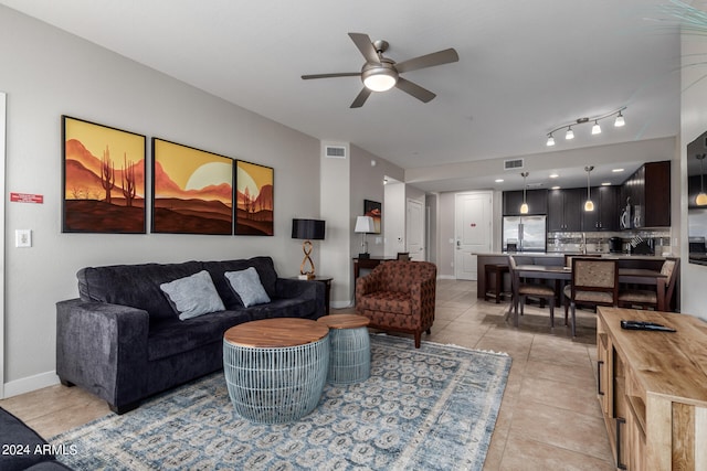 living room with light tile patterned flooring and ceiling fan