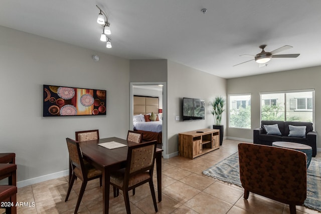 dining space featuring track lighting, light tile patterned floors, and ceiling fan