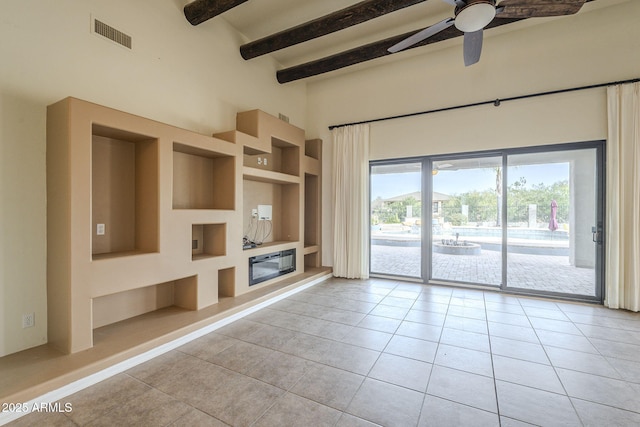 unfurnished living room with light tile patterned floors, built in shelves, beam ceiling, and visible vents