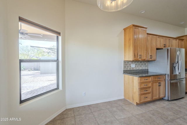 kitchen with tasteful backsplash, baseboards, ceiling fan, and stainless steel fridge with ice dispenser