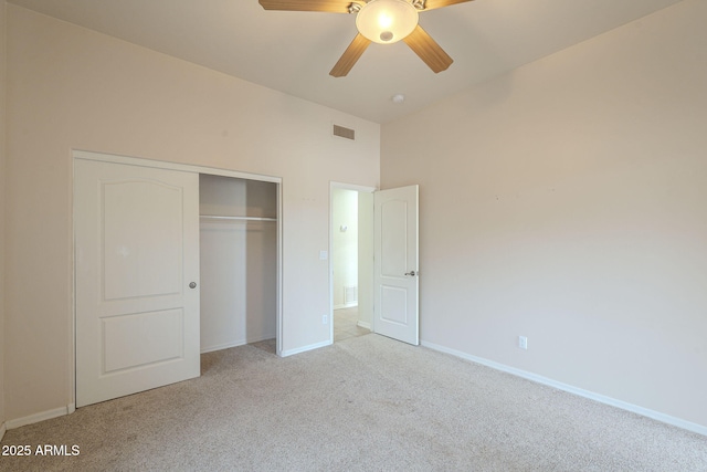unfurnished bedroom featuring a closet, light colored carpet, visible vents, ceiling fan, and baseboards