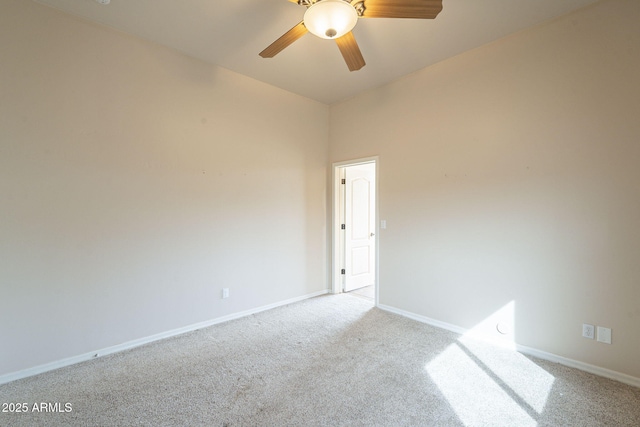 empty room with carpet, baseboards, and ceiling fan