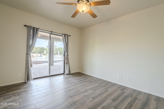 empty room featuring dark wood-style floors, a ceiling fan, and baseboards