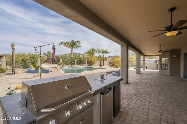 view of patio featuring grilling area, area for grilling, a ceiling fan, a fenced backyard, and an outdoor pool