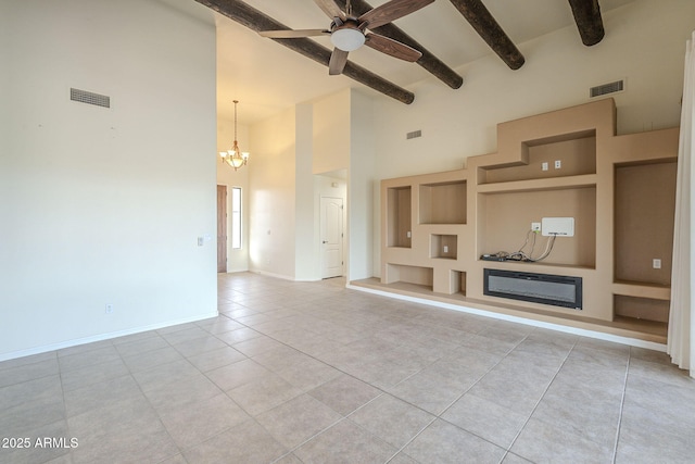 unfurnished living room with light tile patterned floors, visible vents, baseboards, beamed ceiling, and a glass covered fireplace