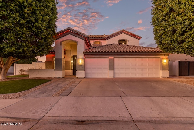 mediterranean / spanish-style home featuring a garage