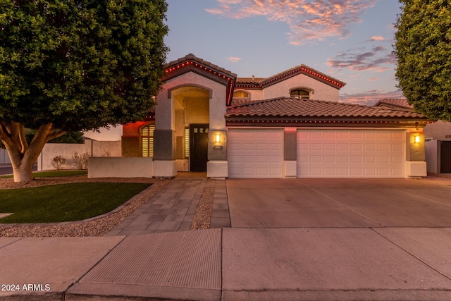 mediterranean / spanish-style house featuring a garage