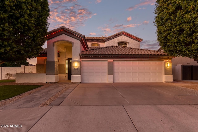 mediterranean / spanish-style home featuring a garage