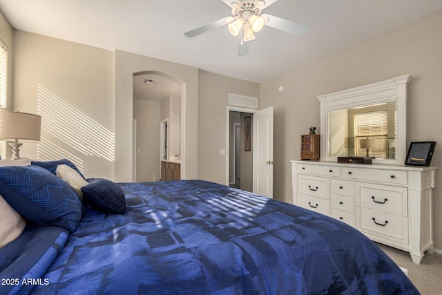 carpeted bedroom featuring ceiling fan and connected bathroom