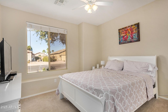 bedroom featuring ceiling fan, light colored carpet, and multiple windows