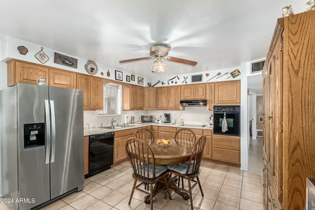 kitchen with light tile patterned floors, sink, backsplash, and black appliances