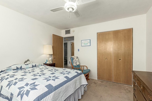 bedroom featuring a closet, ceiling fan, and light colored carpet