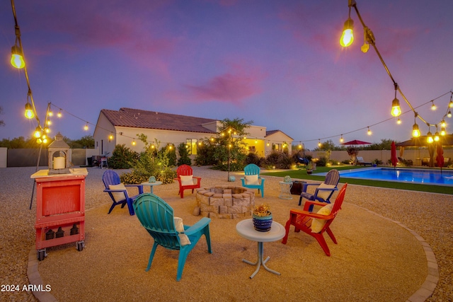 exterior space with a fenced in pool and an outdoor fire pit