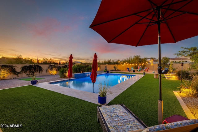 pool at dusk with a lawn