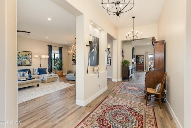 hall featuring wood-type flooring and a chandelier