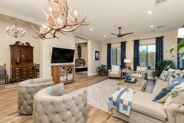 living room featuring light hardwood / wood-style floors and a chandelier