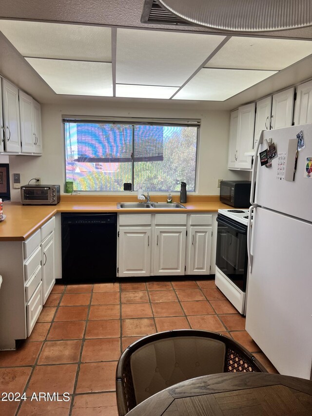 kitchen with a textured ceiling, a brick fireplace, kitchen peninsula, and tile patterned flooring