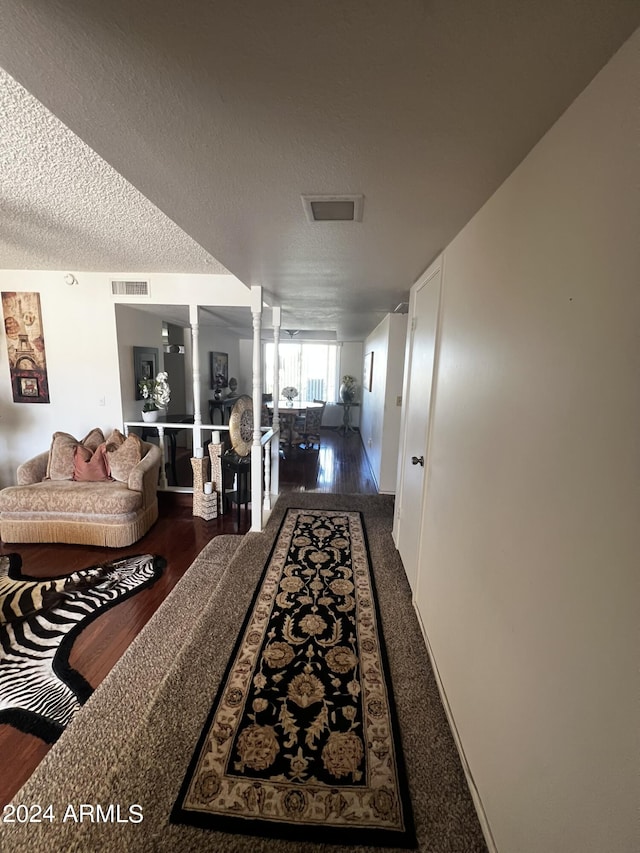 living room with ceiling fan, hardwood / wood-style flooring, and ornate columns