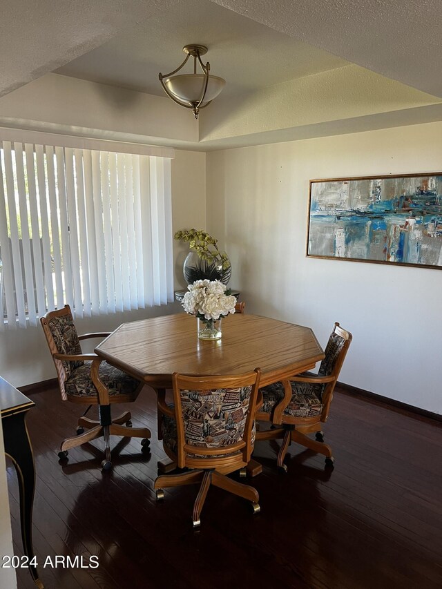 dining area featuring a textured ceiling, hardwood / wood-style floors, and ceiling fan