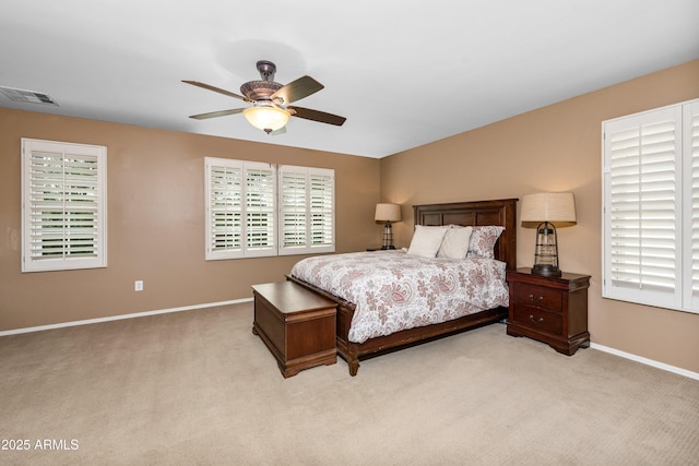 carpeted bedroom featuring visible vents, baseboards, and a ceiling fan