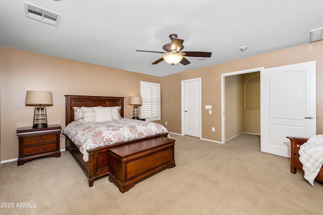 bedroom featuring visible vents, light colored carpet, baseboards, and ceiling fan