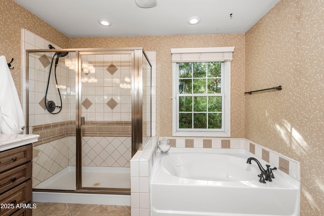 bathroom with a stall shower, a bath, vanity, and wallpapered walls