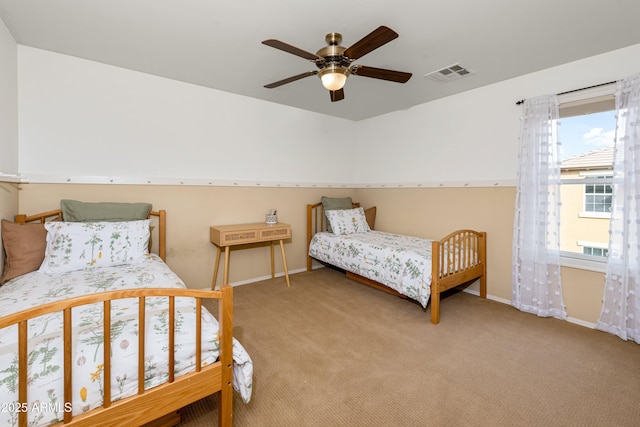 bedroom featuring visible vents, baseboards, a ceiling fan, and carpet flooring