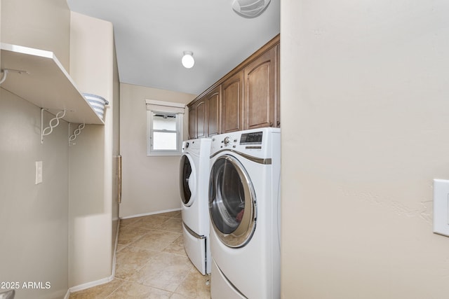 laundry room with light tile patterned floors, visible vents, baseboards, cabinet space, and washing machine and dryer