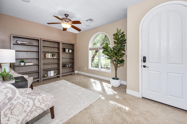 entrance foyer with visible vents, a ceiling fan, and baseboards