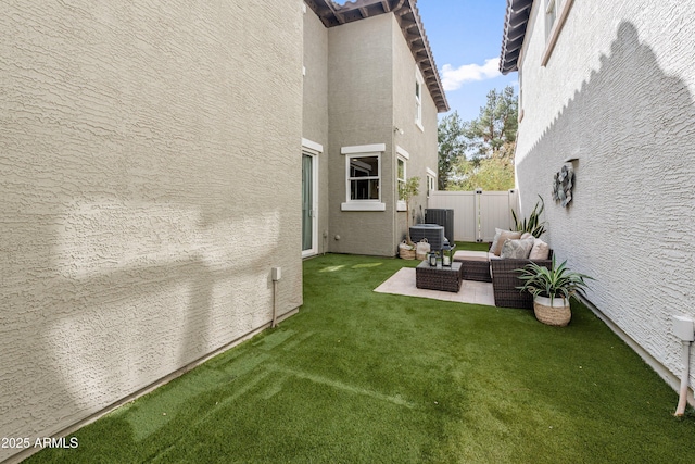 view of yard featuring a patio area, an outdoor hangout area, and fence