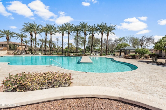 pool with a gazebo and a patio area