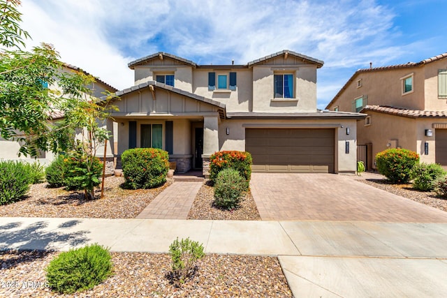 21386 E Kingbird Dr, Queen Creek, AZ 85142 - craftsman-style home with stone siding, decorative driveway, covered porch, an attached garage, and stucco siding
