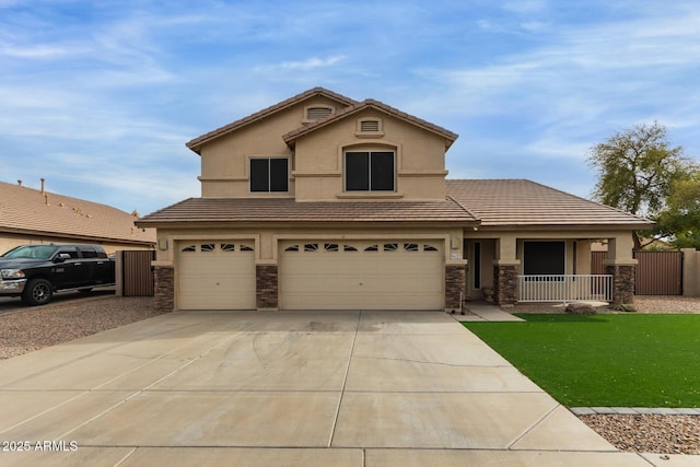 traditional-style house featuring stone siding, fence, an attached garage, and stucco siding