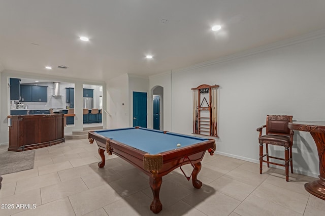 game room featuring arched walkways, light tile patterned flooring, recessed lighting, baseboards, and crown molding