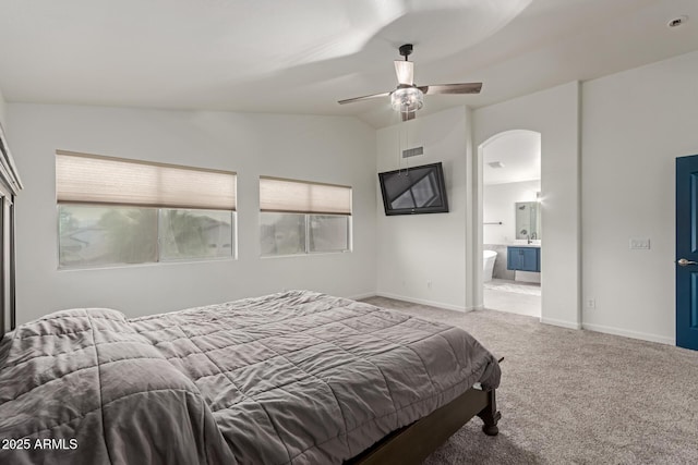 bedroom with arched walkways, lofted ceiling, visible vents, baseboards, and carpet