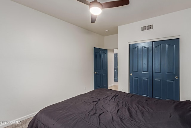 bedroom featuring a closet, visible vents, carpet flooring, ceiling fan, and baseboards