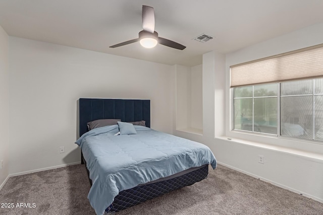 carpeted bedroom with a ceiling fan, visible vents, and baseboards