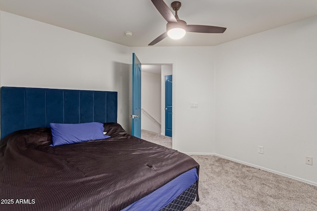 carpeted bedroom with ceiling fan and baseboards