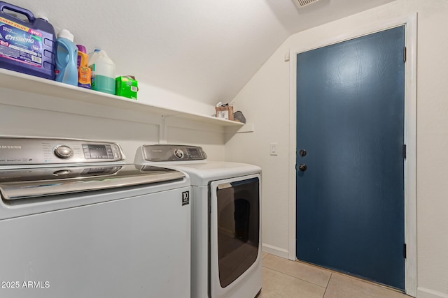 laundry room featuring laundry area, light tile patterned floors, and separate washer and dryer