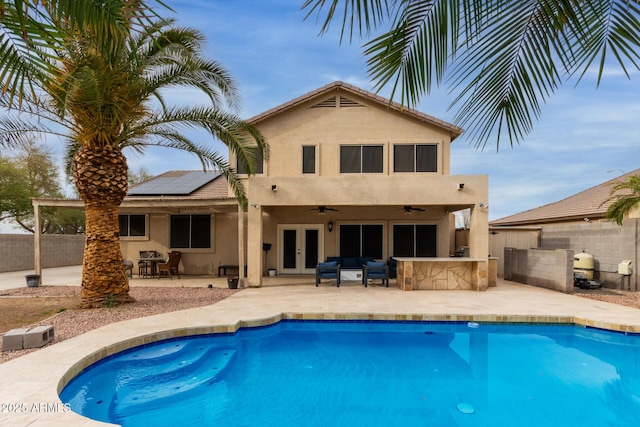 rear view of house featuring french doors, a patio area, outdoor dry bar, and a fenced backyard