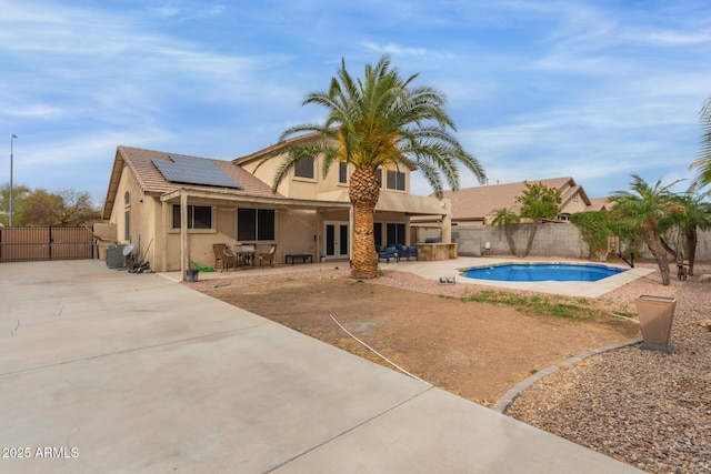 view of pool with a fenced in pool, french doors, a gate, a patio area, and a fenced backyard