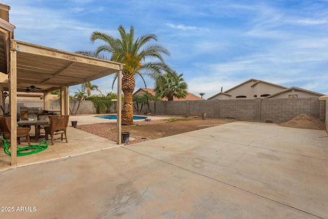 view of patio featuring ceiling fan, outdoor dining area, a fenced backyard, and a fenced in pool