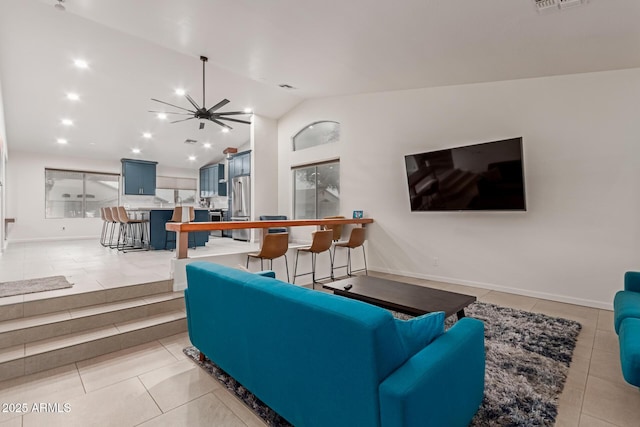 living area featuring baseboards, visible vents, lofted ceiling, light tile patterned flooring, and recessed lighting